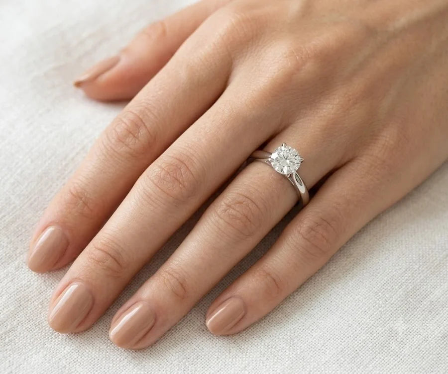 Diamond ring worn on a model — campaign scene